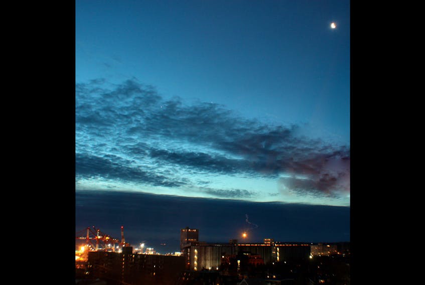 Jan. 29, Michael Boschat was testing a lens when he snapped this lovely early morning photo over Halifax, N.S.  The waning moon is in the top right and those two white specks near the middle - on the edge of the clouds - are Jupiter and Venus.  Michael says he's looking forward to taking a few photos over the next couple of mornings.