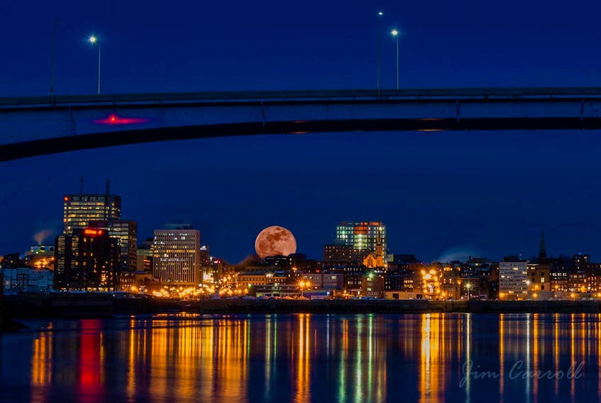 The full moon rising over Saint John, N.B. does not look blue but it was.  The photo was submitted by Jim Carroll and taken the evening of January 31st, 2018. This Full Old Moon was the second full month of the month;  the first was on the first and was the Full Wolf Moon.  This is referred to as a calendar blue moon.