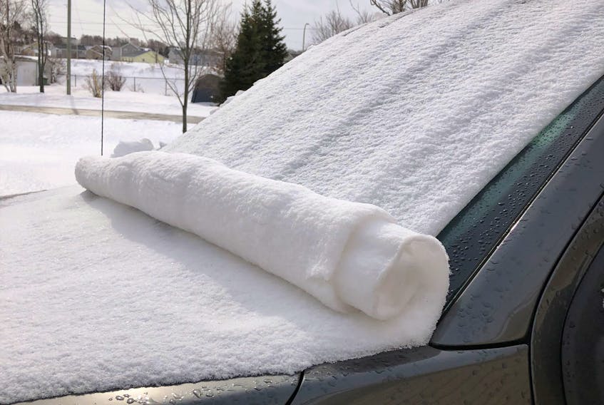 What looks like a rolled up towel on Evelyn Young's car is in fact a snow roller.  It's all about location; Evelyn didn't notice this phenomenon on any other car in the lot.  She snapped the photo on Monday near Sherwood P.E.I.