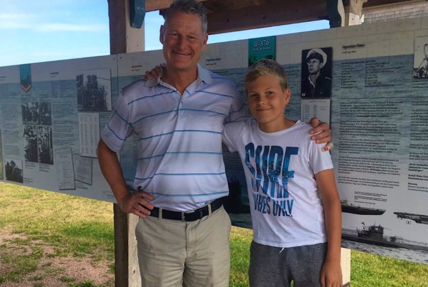 Oliver Engel, left, with his son Lars, in front of the recently installed information panels describing the myth of the sunken German U-boat off the coast of North Cape. 