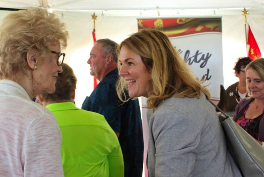 Catherine Callbeck, former premier and senator, congratulates Kim Griffin of Maritime Electric for the successful completion and activation of the new submarine cable.