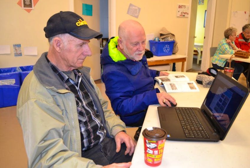 Raymond Wilson, left, gets an introduction to online voting Monday at the O’Leary Christian Education Centre. A voting station was set up there for the day to give seniors and anyone who does not have a computer an opportunity to vote O’Leary for Hockeyville. Rick Cameron guides the first-time computer user through the process.