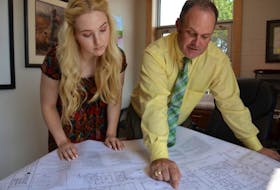 Georgia Gunn, left, a Grade 12 student at Three Oaks Senior High, and principal Jeff Clow look at the plans for the school’s new black box theatre.