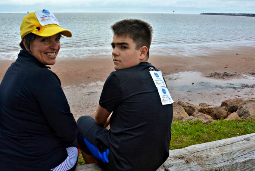 Cindy Murphy and her son Keegan, 12, take a break after running five kilometres down Summerside’s boardwalk in memory of husband and father, Mark Murphy, while also raising funds for Hospice P.E.I.
