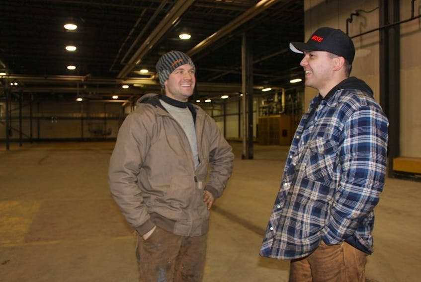 Patrick Szarc, left, and Stephen Slicker talk about MacDougall Steel moving into the former McCain French fry plant in Albany. On Wednesday, the province announced MSE’s purchase of the plant.