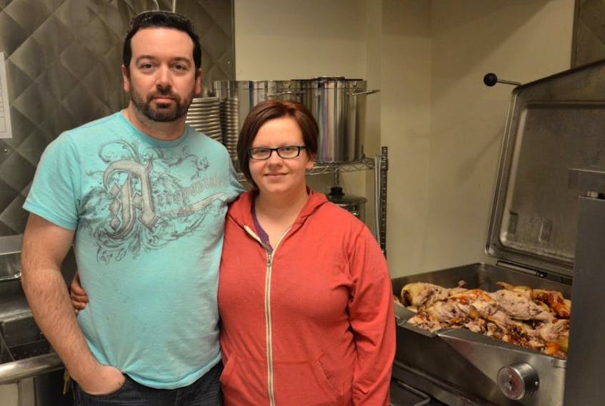 Mike and Julie Taylor prepare chicken for their two businesses, Bony Broth Co. and Harmony Hills. They currently use the kitchen at Centre 150 in Summerside, but will soon have their own to work out of.