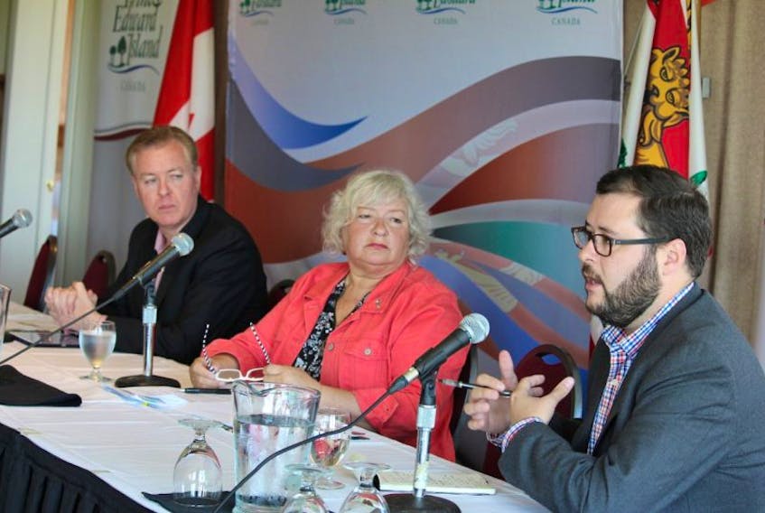 John Kimmel, right, talks during the panel discussion at the recent economic forum put on by the provincial government while his fellow panellists, David Dunphy, left, and Audrey Shillabeer listen.