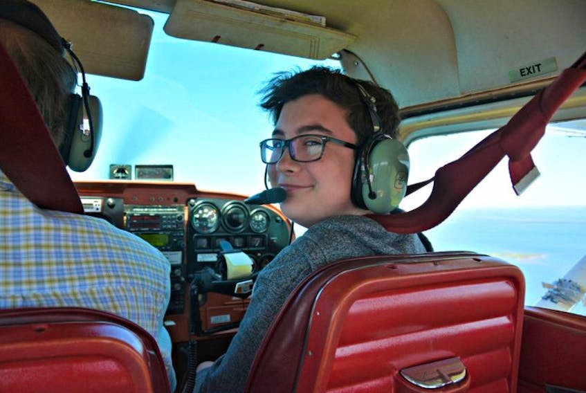 Cole Sinclair, 14, of Wellington, grins from ear to ear as he takes control of the small C-GDZA aircraft, under the watchful guidance of his instructor, Dave Thomas, and learns how to fly. 
