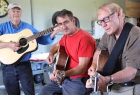 John Campbell, left, Wayne Gallant and Harold Noye play the guitars they made.