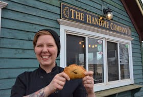 Sarah Bennetto O’Brien holds a handpie outside of her shop, the Handpie Company in Gateway Village, Borden-Carleton. The shop used to be called Scapes, but has been rebranded to focus on handpie production.