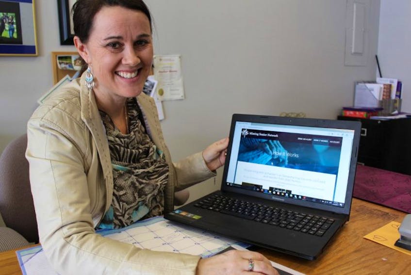 Heather Blouin pulls up the homepage of the Missing Senior Network on her laptop. The network allows families, friends and businesses to work together to find a missing person with dementia when they have wandered off.