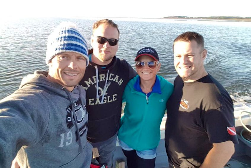 Four divers, Arjan Stutvoet, left, Conrad Kippenhuk, Laura Brake and Kelly Campbell, discovered a shipwreck off the shore of Rice Point in the Northumberland Strait. They believe the wreck is the Ferguson, a dredging barge that sunk in the area in the 1920s. 