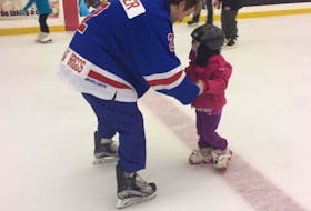 Sebastien Cormier helps five-year-old Presley skate.