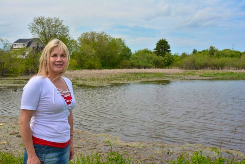 Tracy Brown, executive director of the Bedeque Bay Environmental Management Association, at the old ice pond on Notre Dame Street in Summerside. The association recently received a significant funding commitment from the federal government to help rehabilitate the property.