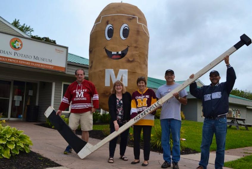 O'Leary Kraft Hockeyville committee members, from left, Bill MacKendrick, Jo-anne Wallace and Della Sweet, along with Glen Sweet and O'Leary Recreation Director Jeff Ellsworth hold up Bud's giant Hockey stick.