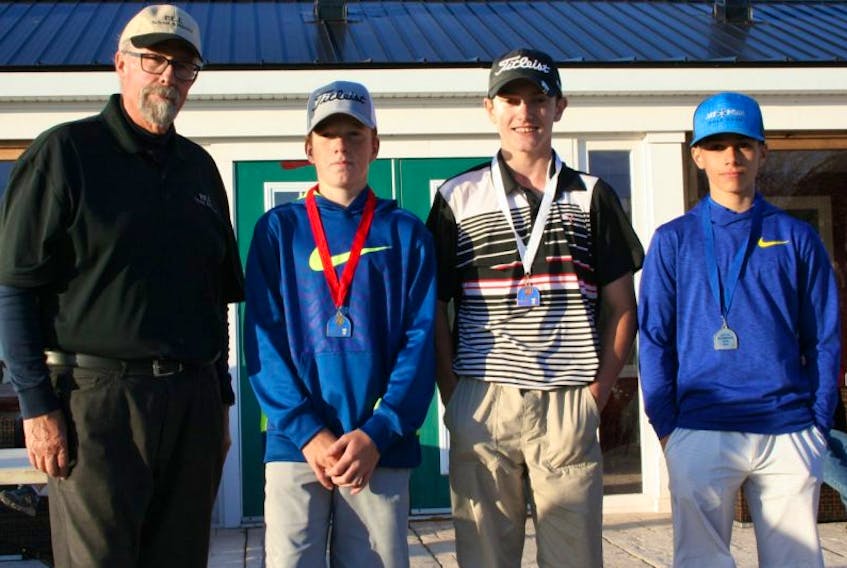 P.E.I. School Athletic Association golf co-commissioner Wayne Denman congratulates the top-three finishers in the provincial intermediate championships at the Ocean View Golf Club in Linkletter on Wednesday. From second left: East Wiltshire’s Bradley Chisholm, gold; Vernon River’s Evan Doherty, bronze, and Birchwood’s Sam Parsons, silver.