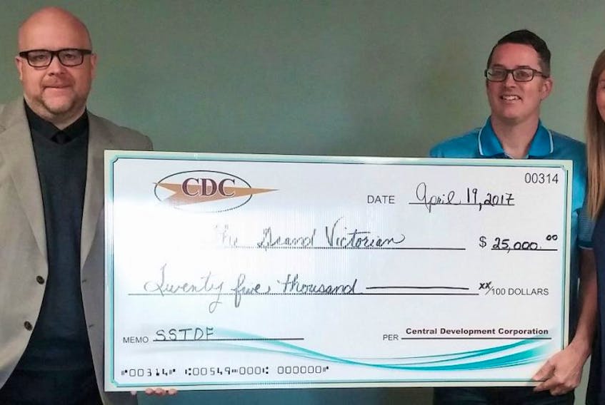 Kent Bruyneel, (left) executive director of CDC, presents Marly and Greg Anderson of The Grand Victorian, with the cheque.