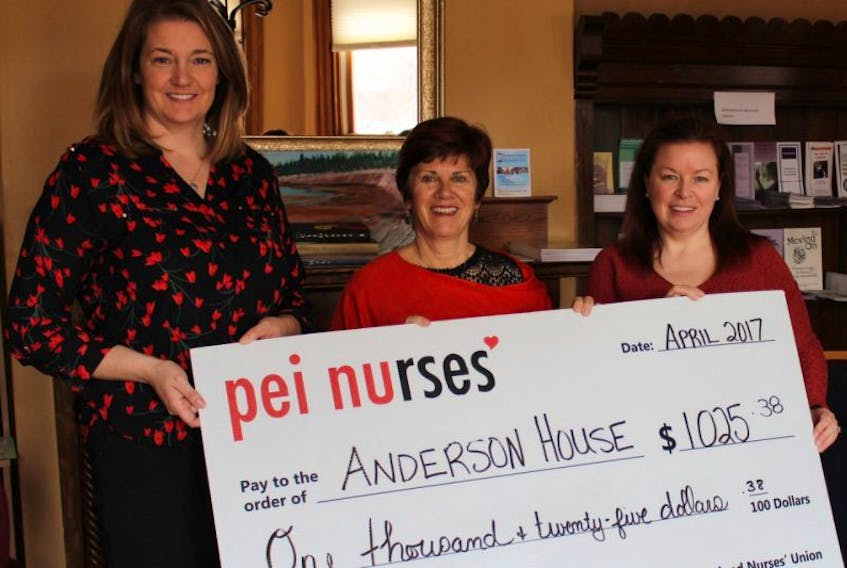 Dara Rayner (left), operations manager, and Kim McGuigan (right), shelter staff member at Anderson House, accept the donation of $1,025, from Mona O’Shea, president of the P.E.I. Nurses’ Union.