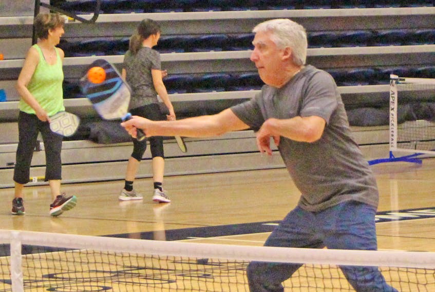 Mike Hinchey reaches for a return during a recent Pickleball Antigonish Society workout at St. F.X.’s Oland Centre. Corey LeBlanc