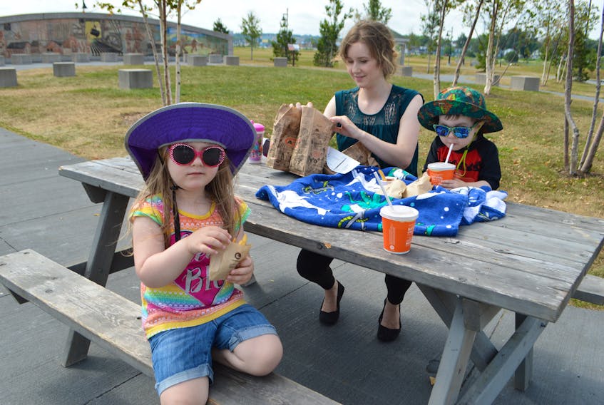 Julie Hicks of Westmount, enjoyed a picnic at the Open Hearth Park in Sydney with her children Rosie, 4, and Will 2, on Wednesday. Hicks said they visit the park a few times in the summer. The children were at the playground before taking a picnic break. Sharon Montgomery-Dupe • Cape Breton Post