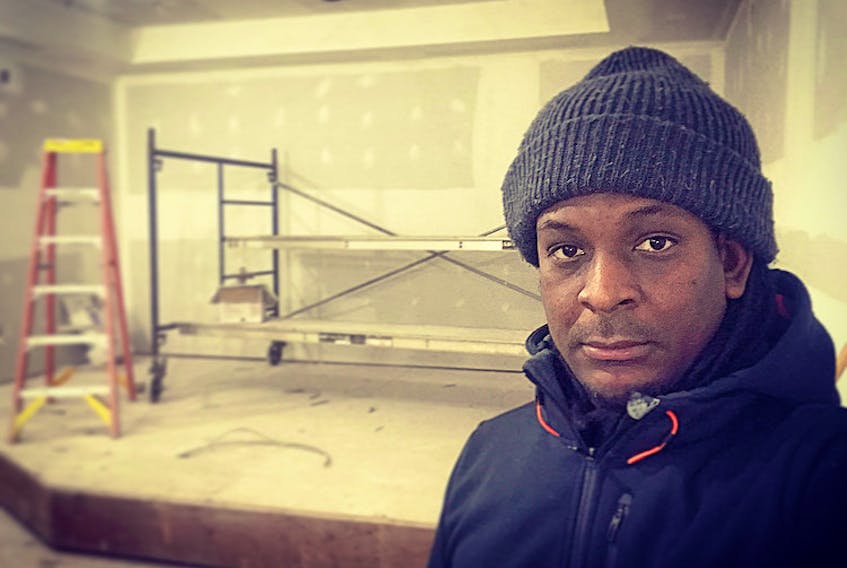Derrick Pierre overseeing the construction of the new The Commune location