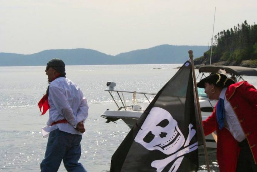 Pirate Peter Easton (played by Tom Hallett) forces a captured Frenchman (Clifford Powell) to walk the plank during a recreation of Easton’s arrival in Happy Adventure, Bonavista Bay as part of the community’s anniversary celebrations in August 2017.