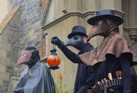 Originally designed in the early 1600s, these plague doctor outfits were an early form of personal protective equipment. It was then exaggerated when it was adopted by people attending the Venetian Carnival, cultural historian and author Ainsley Hawthorn said. — Andrew Waterman/The Telegram
