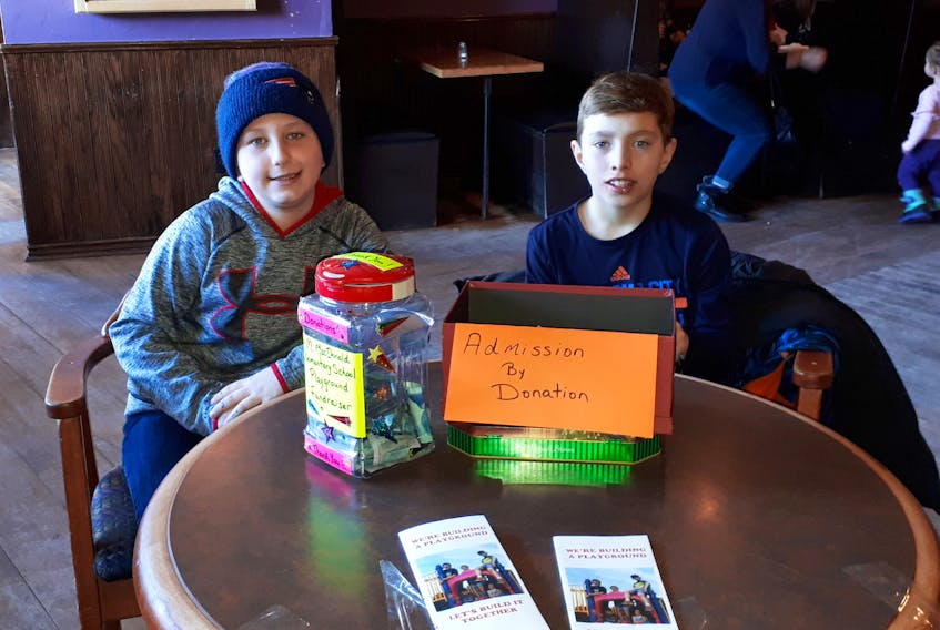 H.M. MacDonald Elementary School students Cameron Fraser (Grade 6) and Calder MacKenzie (Grade 5) help out at the Feb. 17 fundraising musical event by collecting donations.