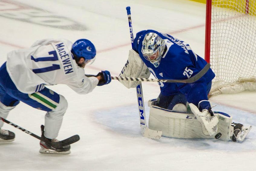 Zack MacEwen fires a shot on Jacob Markstrom during a Vancouver Canucks practice at Rogers Arena this week.

