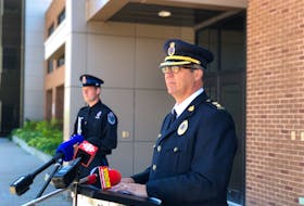 Royal Newfoundland Constabulary Supt. Tom Warren speaks to members of the media outside RNC headquarters in St. John's Wednesday morning, providing an update on the investigation into the shooting death of 47-year-old James Coady on Craigmillar Avenue three days earlier. Const. James Cadigan, the RNC's media relations officer, is seen in the background.