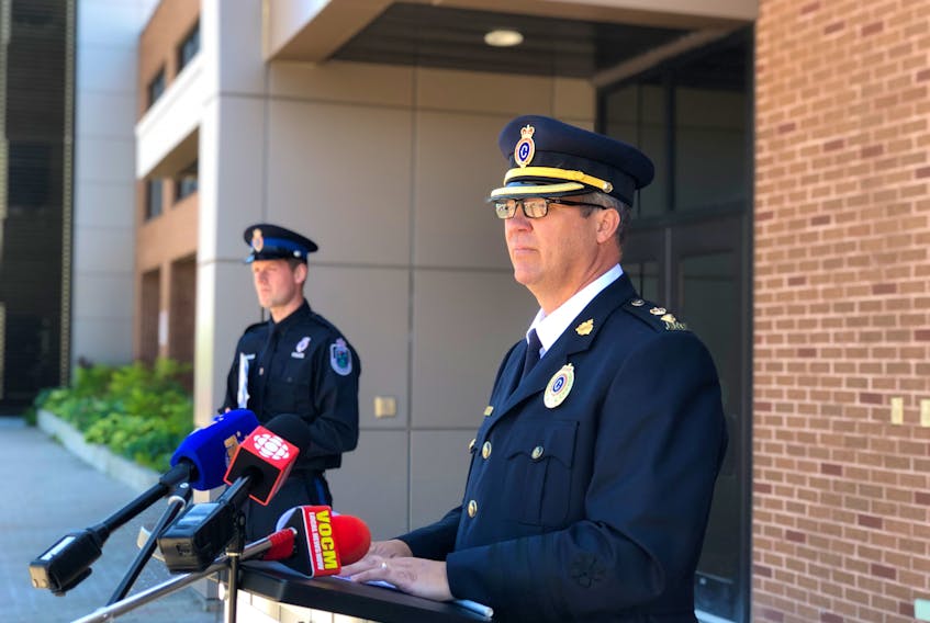 Royal Newfoundland Constabulary Supt. Tom Warren speaks to members of the media outside RNC headquarters in St. John's Wednesday morning, providing an update on the investigation into the shooting death of 47-year-old James Coady on Craigmillar Avenue three days earlier. Const. James Cadigan, the RNC's media relations officer, is seen in the background.