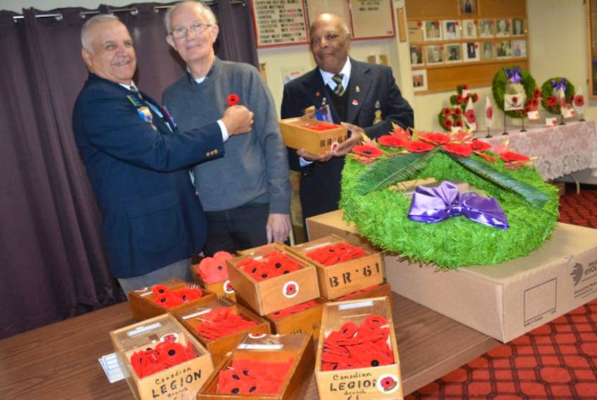 <p>On behalf of the Town of Yarmouth, Jim MacLeod receives a poppy from Royal Canadian Legion Branch 61 president Charles Crosby and poppy campaign chairman Ed Fells on Oct. 28, the first day of their annual poppy campaign.</p>