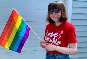 Taylor Linloff proudly shows of her Pride flag outside her home in Port Hawkesbury, where she has lived her whole life. The queer woman has organized Port Hawkesbury's first Pride parade, taking place on June 27, as a way to show the LGBTQ+ community in the Strait Area there is support, there is a community and there is no room for hate. CONTRIBUTED 