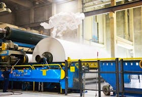 Supercalndered paper flies through the air as a roll is finished at Port Hawkesbury Paper.&nbsp;