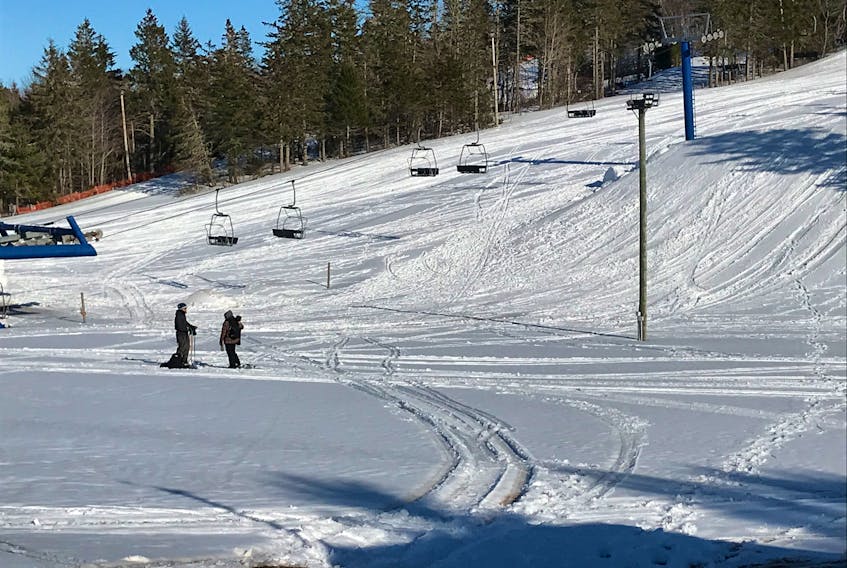 Some avid skiers didn't let the season closure of the Mark Arendz Provincial Ski Park in Brookvale stop them from hitting the slopes last Saturday. Lacking a lift, they skied down the hill and hiked back up, as well as spent time skiing in the terrain park. Here a couple of skiers take a break near the bottom of the hill as they wait for the rest of their group to come down. To watch a video, go to www.theguardian.pe.ca.
