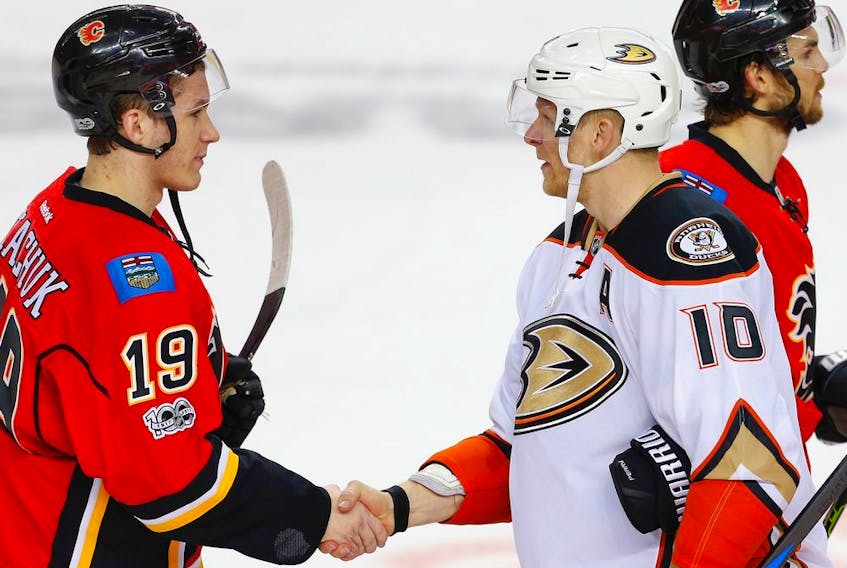 The Calgary Flames’ Matthew Tkachuk and Corey Perry, then a member of the Anaheim Ducks, Shake after Game 4 of their 2017 Western Conference quarter-final series at the Saddledome. The Ducks won 3-1 to sweep the best-of-seven series. Al Charest/Postmedia