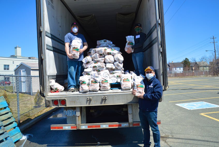 Some 50,000 pounds of potatoes, donated by McCain Foods Canada, were distributed across Cape Breton Friday by volunteers from the Salvation Army. The donation was aimed at helping individuals and families who are struggling to make ends meet in a time of global pandemic. Among the volunteers were, from left, Ray Adams, Heidi Nelson and Jim Connors. CAPE BRETON POST PHOTO 