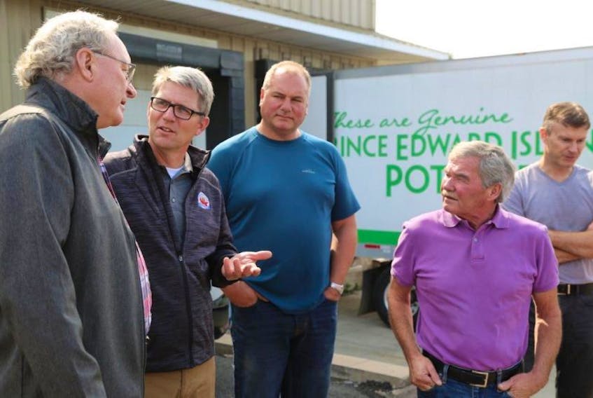 P.E.I. producers are sending more than 40,000 pounds of Island produce to the Southern U.S. for victims of hurricane Irma. From left, Premier Wade MacLauchlan speaks with Greg Donald of the P.E.I. Potato Board, Phil Visser of Sherwood Produce, Don Read of the P.E.I. Vegetable Growers Co-Op and Jamie Wood of Cavendish Produce. 