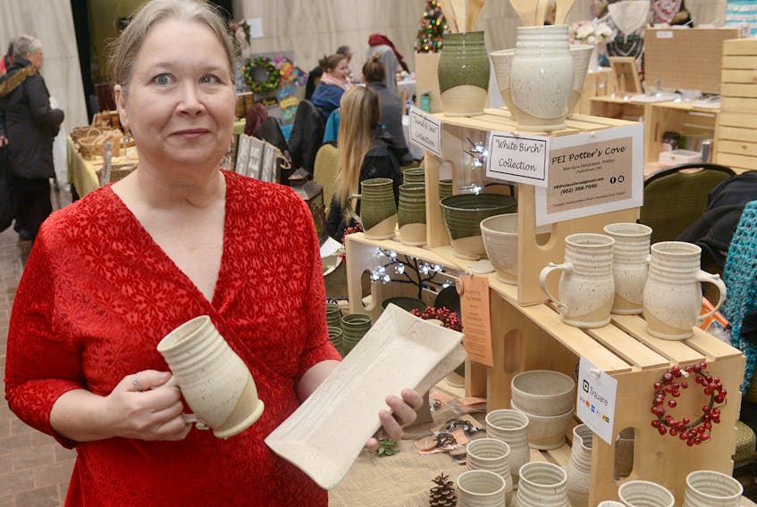 Marilyn MacLean, of P.E.I. Potters Cove, shows some of her work during a craft fair at the Confederation Centre of the Arts. MacLean, who has 35 years of experience making pottery, has seen the demand for her product grow rapidly since creating a home studio last year. MacLean plans to sell her products at local craft shops, the Colonel Gray craft fair and Farm Day in the City before she makes it a full-time job in her retirement. MITCH MACDONALD/THE GUARDIAN