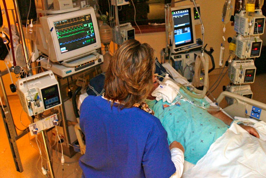 A nurse checks a patient at a Halifax hospital in this file photo. Dalhousie University is developing a certificate program that would give some nurses prescribing authority.