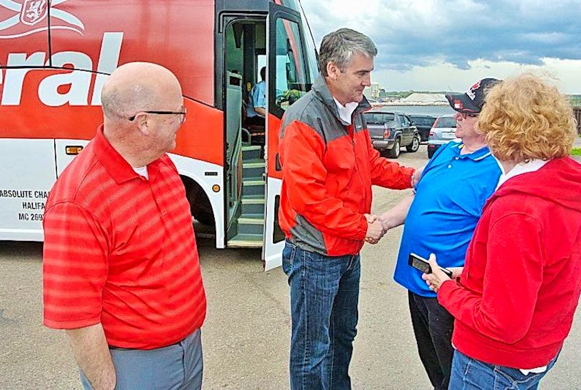 Premier Stephen McNeil and Cumberland North Liberal candidate Terry Farrell talk to Scott Daniels and Diane Daniels during a campaign stop in Pugwash on Friday.
