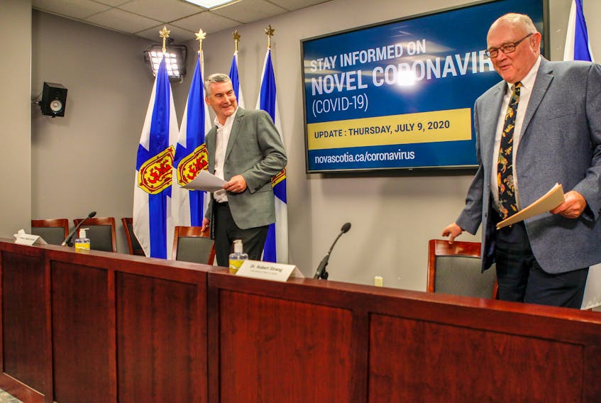 Nova Scotia Premier Stephen McNeil and Dr. Robert Strang, chief medical officer of health, arrive for their COVID-19 news briefing on Thursday.