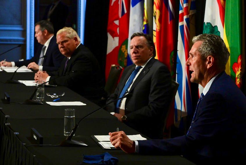 Manitoba Premier Brian Pallister, right, speaks as Quebec Premier Francois Legault, Ontario Premier Doug Ford, and Alberta Premier Jason Kenney look on during a press conference in Ottawa on Friday, Sept. 18, 2020.