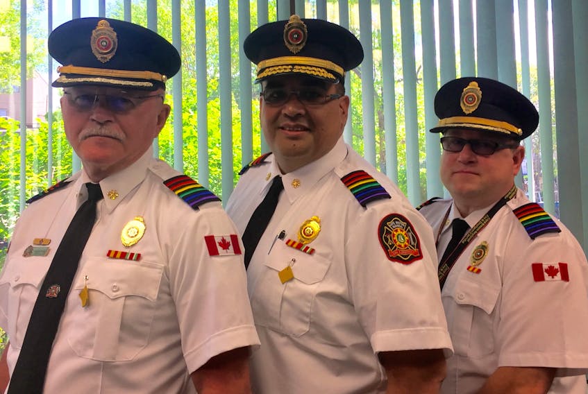 Cape Breton Regional Fire Service deputy chief Gilbert, from left, Chief Mike Seth and deputy chief Chris March wear their Pride-coloured epaulets to celebrate Pride month and the local LGBTQ community. CONTRIBUTED