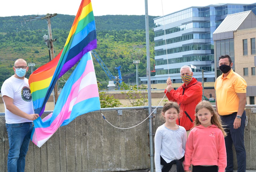  The normal speeches and crowds cheering on were absent in the anything but normal year of 2020 when the pride and trans flags were raised at St. John's City Hall Friday. Missing this year, as well, will be the several thousand-strong pride parade for the lesbian, gay, bisexual trangendered plus (LGBT+ community and their supporters, but virtual events and family and friends gathering in their bubbles are filling in. From left raising the flags are St. John's Pride finance co-chair Gorvin Greening, Mayor Danny Breen and Ward 3 Coun. Jamie Korab. In front are Sesily Howlett, 7, and Kendra Korab, 6. BARB SWEET/THE TELEGRAM