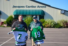 The Alberton-based Western Regals head coach Jason Smallman, left, holds Ethan Reilly’s No. 7 while assistant coach Joey Dumville displays Alex Hutchinson’s No. 19 in front of the P.E.I. Under-18 Hockey League’s home arena, Jacques Cartier Arena. The P.E.I. Under-18 Hockey League team is retiring both numbers after Reilly and Hutchinson died after the boat they were in capsized on Sept. 16. 