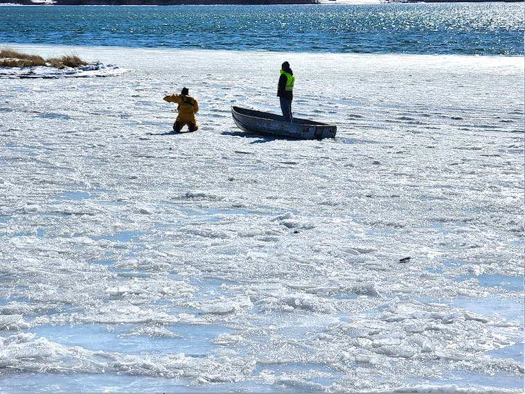 A member of a Dominion Volunteer Fire Department’s water rescue unit assists Rick Ellerbrok of Sydney, an employee with Cape Breton Regional Municipality public works department in New Waterford, in getting back to shore, after the worker heroically rescued a dog that fell through the ice in Lingan, Thursday afternoon. Ellerbrok strenuously paddled across jagged ice to rescue the dog. The Scotchtown Volunteer Fire Department also assisted at the scene. CONTRIBUTED