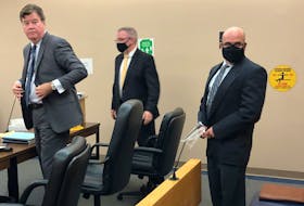 Elementary school principal Robin McGrath (right) prepares to leave the courtroom Tuesday with his lawyers Tom Johnson (left) and Ian Patey. He'll be back in provincial court in St. John's at the end of the month, when Judge David Orr will give his decision on an application made by prosecutor Shawn Patten.