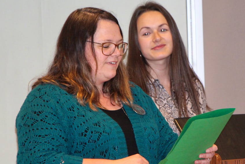 Sexual assault nurse examiner (SANE) co-ordinator from the Antigonish Women’s Resource Centre and Sexual Assault Services Association Heather Blackburn (foreground), and Avery Carter, sexual violence prevention and support with Family Services of Eastern Nova Scotia, address the crowd gathered for a proclamation signing event in recognition of April being Sexual Assault Awareness Month, April 9, at the People’s Place Library.