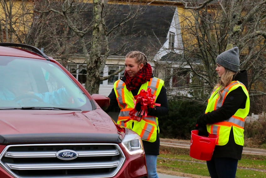 Sisters Cassidy and Miranda Boutilier volunteered their time Nov. 18 to stop motorists as part of MADD Canada’s Project Red Ribbon one-day blitz in the Annapolis Valley.